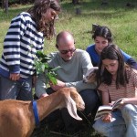 After all the work is done, Jeff and the kids try to identify a tree with berries. Honey may look interested in the field guide, but what she really wants is to eat those leaves!