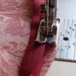 Sew single fold bias tape to right side of fabric - bias tape set in 1/8" from edge of fabric, follow fold line for seam