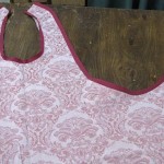 Press bias tape out from edges of apron and flat