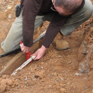 Cutting the old water line to the house, to tap in the new water line